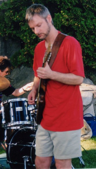 Photo of Ian playing his fender Strat